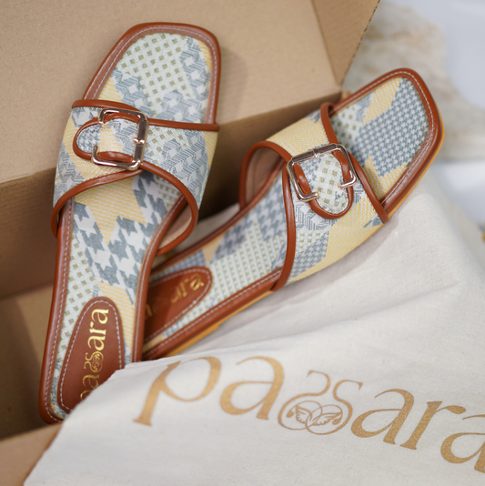 Pair of floral-patterned slippers with brown straps on a branded cloth, with 'ara' branding visible.